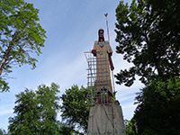 A large tall tower with a clock on the side of a buildingDescription generated with high confidence