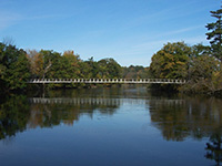 A body of water surrounded by treesDescription generated with very high confidence